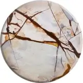 Stone cabochon, creamy white with brown veins, circular polished surface displaying blue-gray hues and geological fracture patterns.